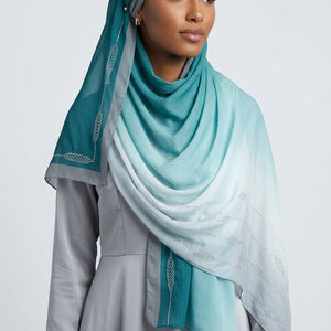 Gradient scarf transitioning from light blue to white on a white background