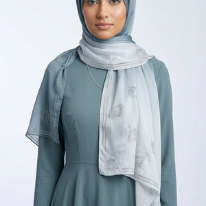 Light blue scarf with floral patterns on a white background