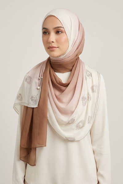 White fabric with floral embroidery draped over a white background