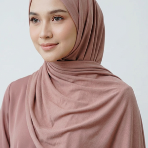 Pink hijab draped over a white surface