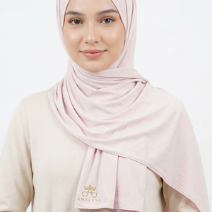 Rolled-up light pink fabric on a white background