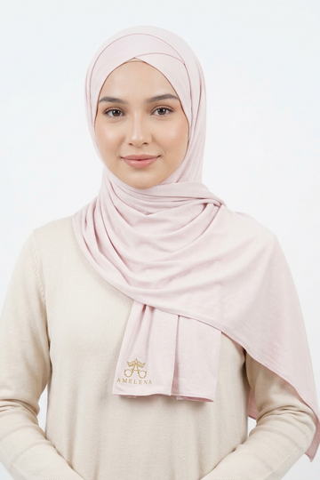 Rolled-up light pink fabric on a white background