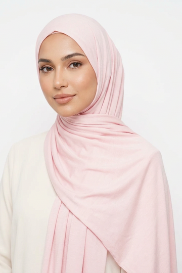 Pink fabric roll on a light pink background