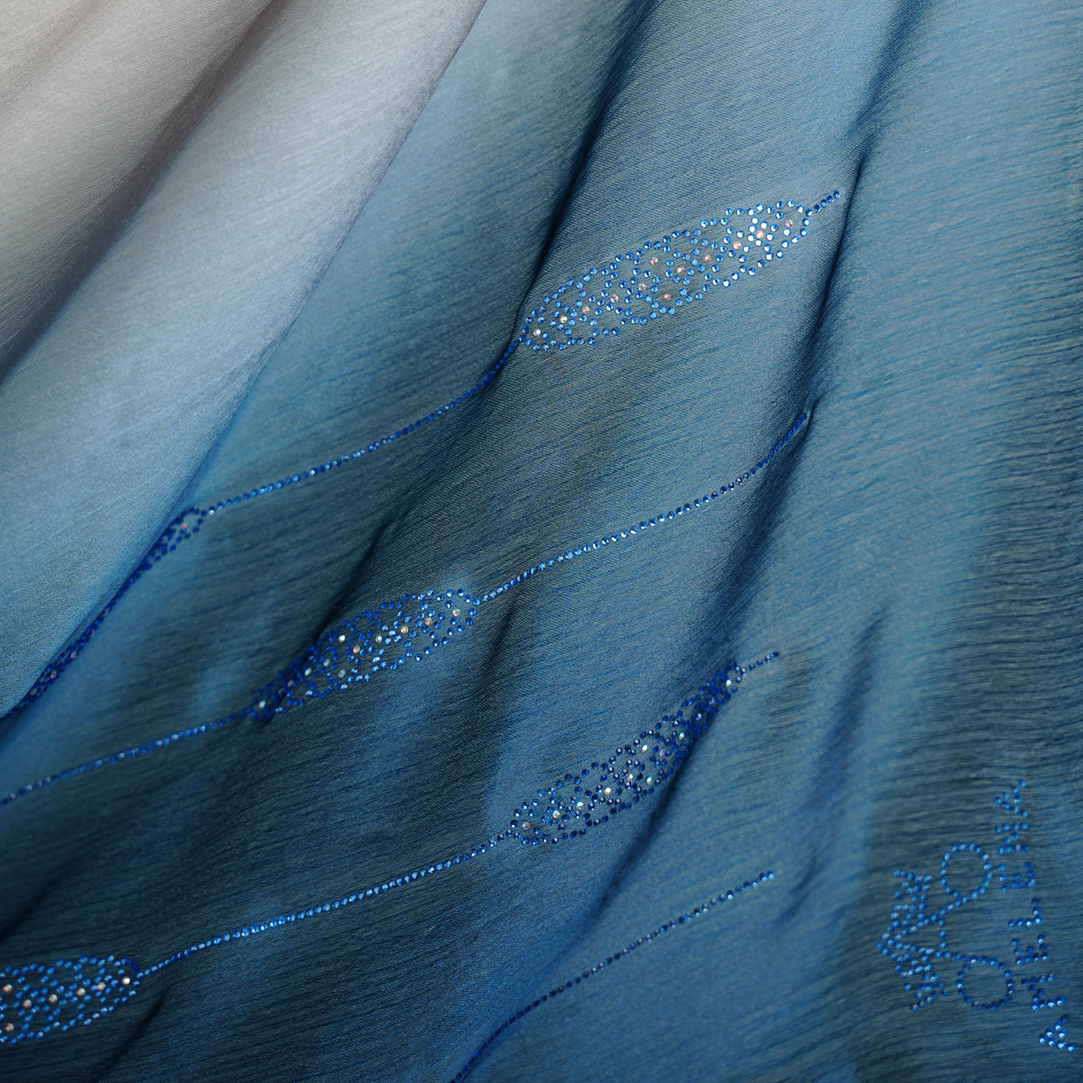 Close-up of blue fabric with decorative stitching