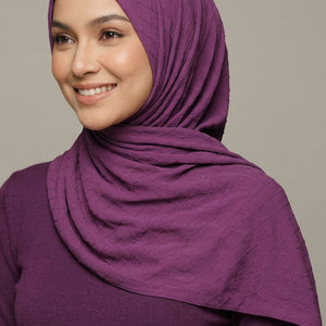 Purple quilted fabric with 'AMELENA' branding.