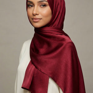 Close-up of red fabric with Ameleena branding.