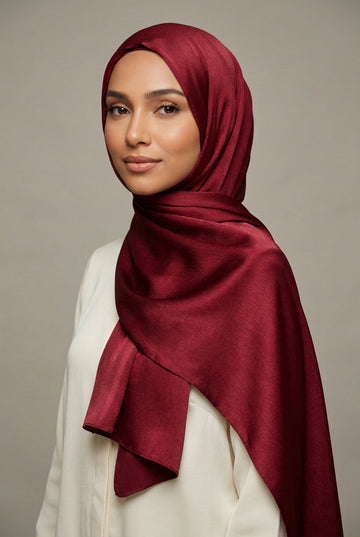 Close-up of red fabric with Ameleena branding.