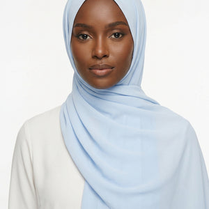 Light blue scarf with a brand label on a white background