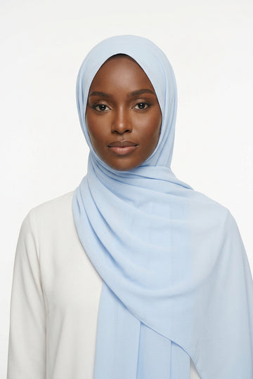 Light blue scarf with a brand label on a white background