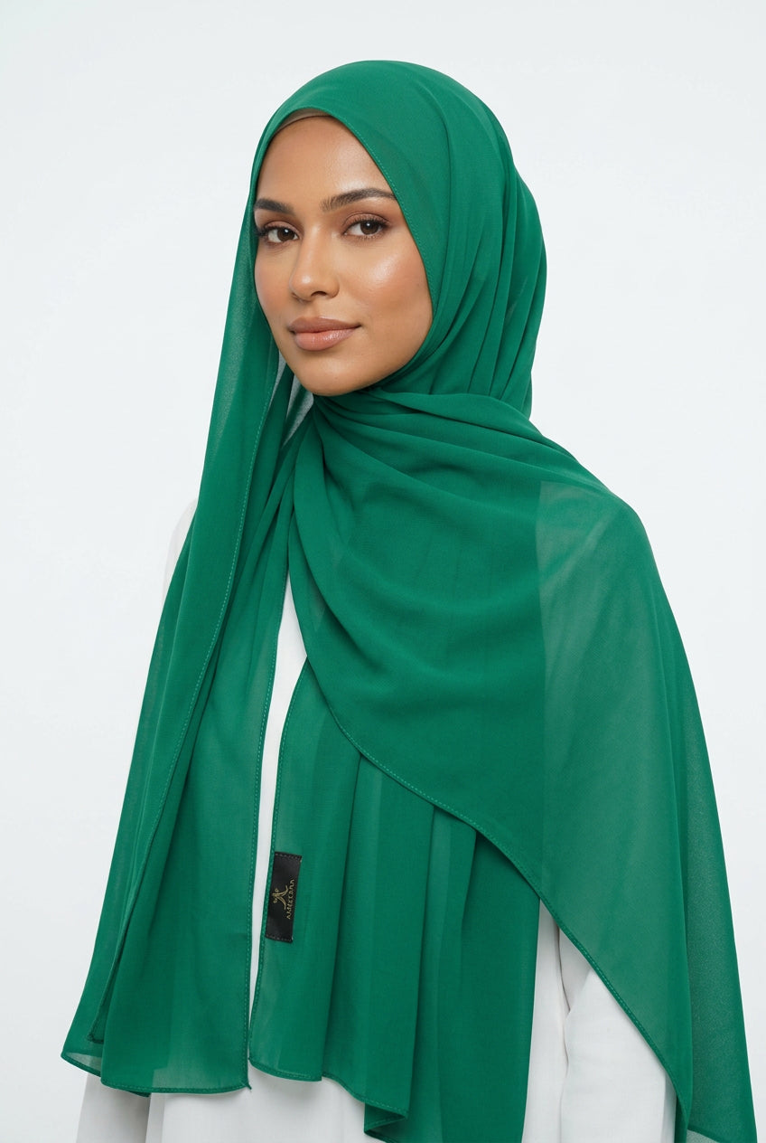 Green scarf on a white background with 'AMELENA' branding.