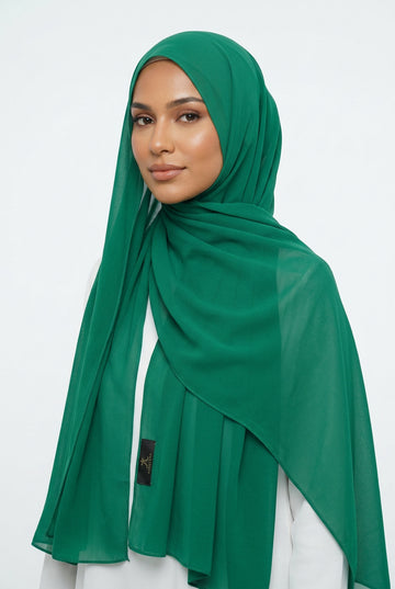 Green scarf on a white background with 'AMELENA' branding.