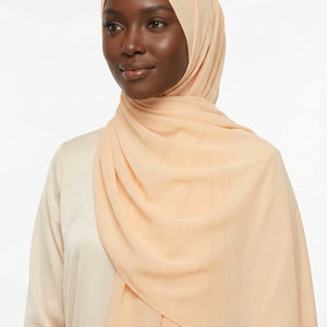 Peach-colored scarf on a light gray background
