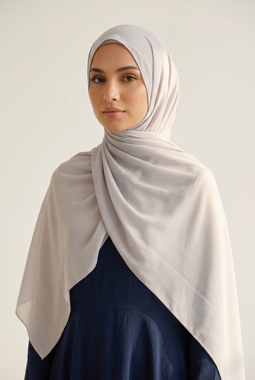 Light gray scarf with subtle pattern on a white background