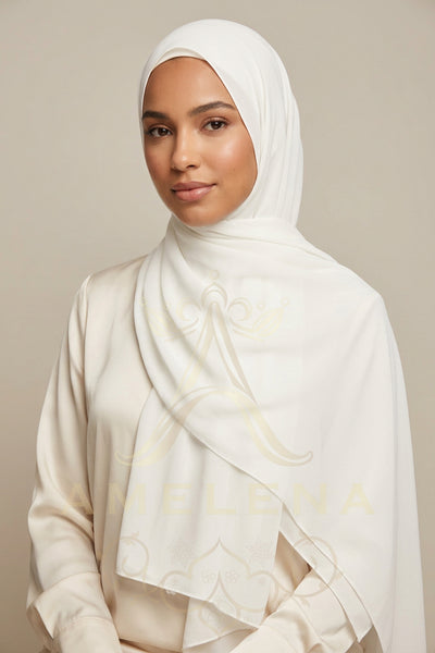 White scarf with gold embroidery on a white background