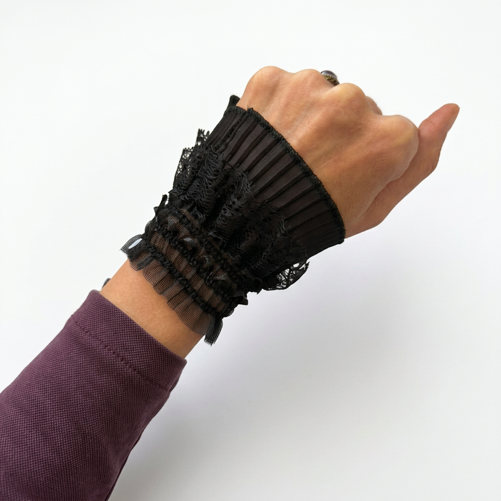 Black lace cuff worn, close-up view