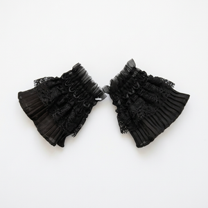 Black lace cuff worn with plum sleeve