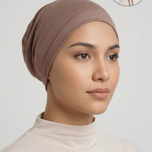 A brown fabric head covering or cap displayed on a mannequin head against a light gray background, with a small circular inset in the top right showing the back view of the tied head covering.