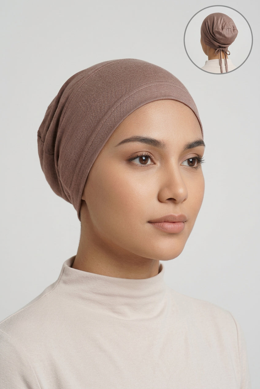 A brown fabric head covering or cap displayed on a mannequin head against a light gray background, with a small circular inset in the top right showing the back view of the tied head covering.