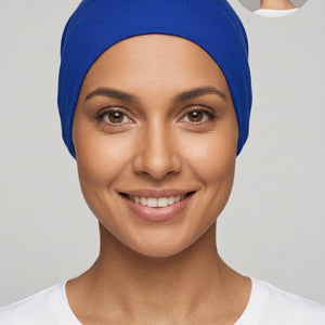 A royal blue fabric head covering or hijab displayed on a mannequin head, with a small circular inset showing the back view of the head covering.