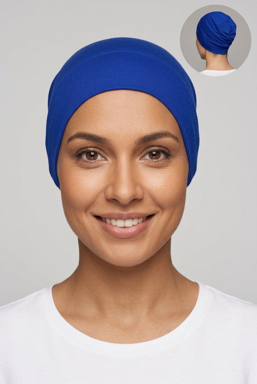 A royal blue fabric head covering or hijab displayed on a mannequin head, with a small circular inset showing the back view of the head covering.