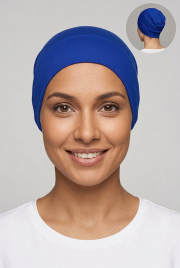 A royal blue fabric head covering or hijab displayed on a mannequin head, with a small circular inset showing the back view of the head covering.