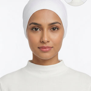 A white fabric head covering or cap displayed on a mannequin bust against a plain light background, with a small circular inset showing the back view of the product on a mannequin head.