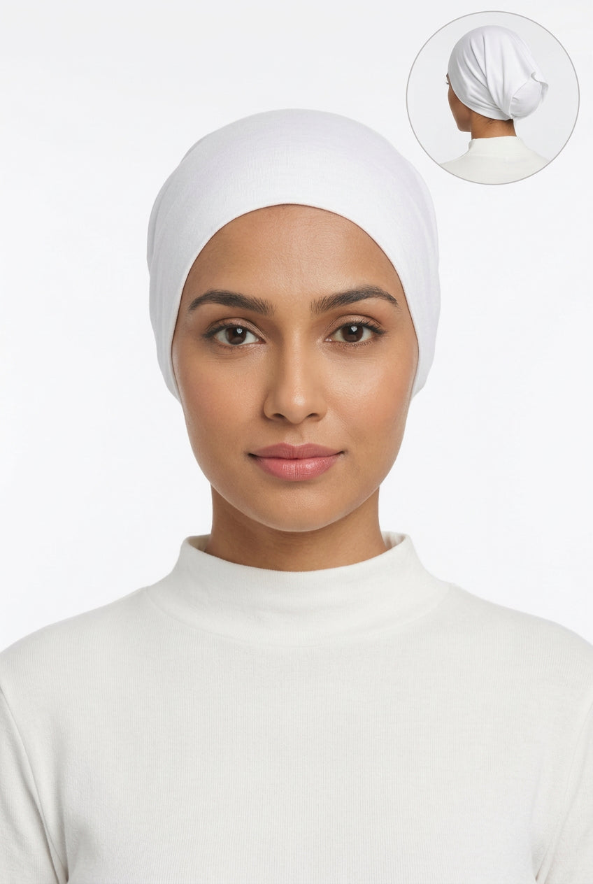 A white fabric head covering or cap displayed on a mannequin bust against a plain light background, with a small circular inset showing the back view of the product on a mannequin head.